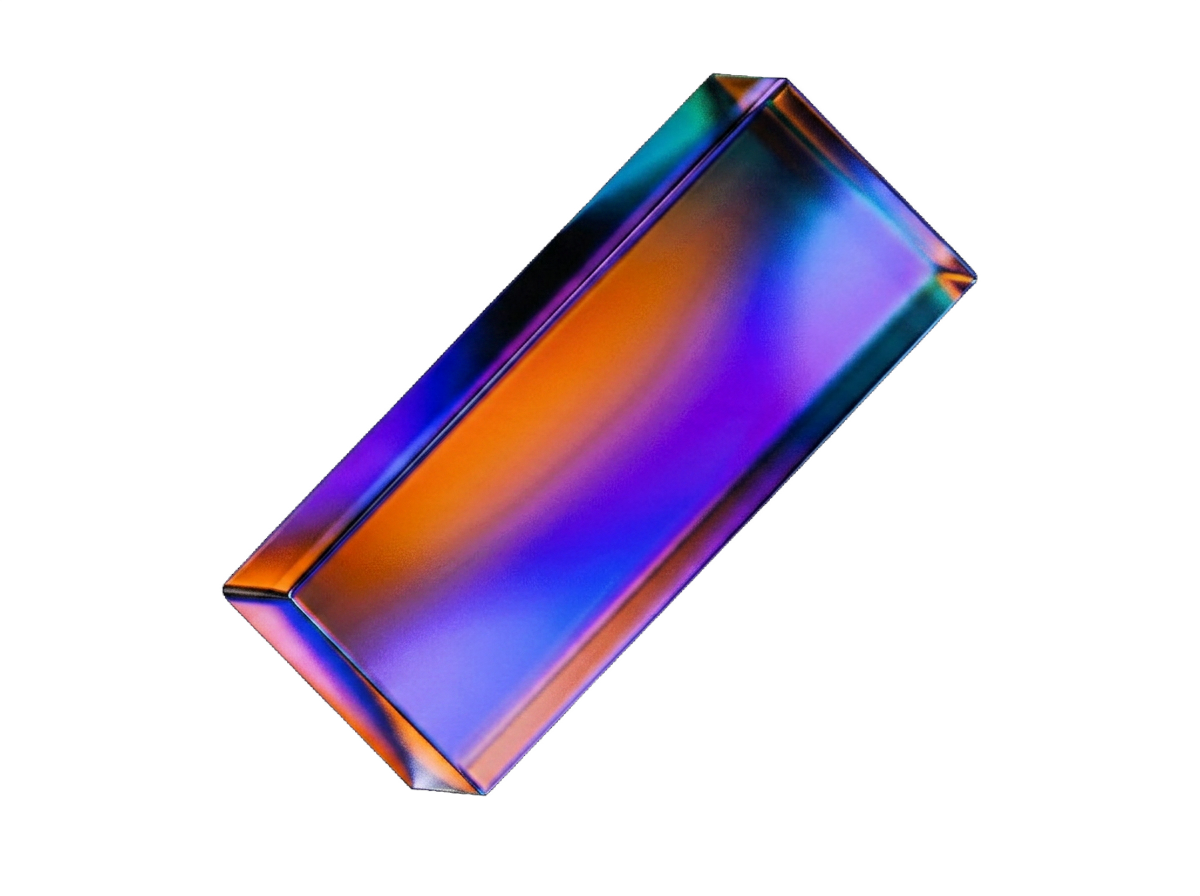 Iridescent glossy glass block with saturated gradient of purple, blue, orange, and teal, tilted at an angle against white background